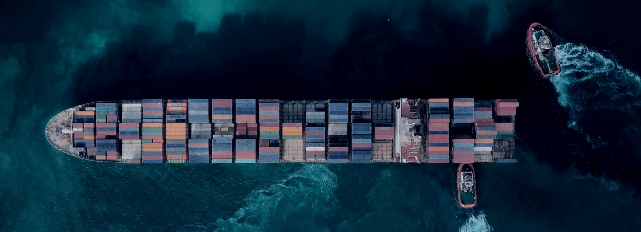 tug boats moving cargo ship